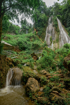 Serene Namtok Waterfall Behind Gorge in Lush Tropical Landscape
