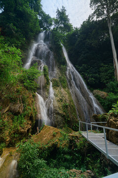 Serene Waterfall Amidst Lush Greenery Near Stunning Gorge