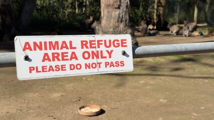 Animal Refuge Area Warning Sign with Kangaroos in Background © blueringmedia