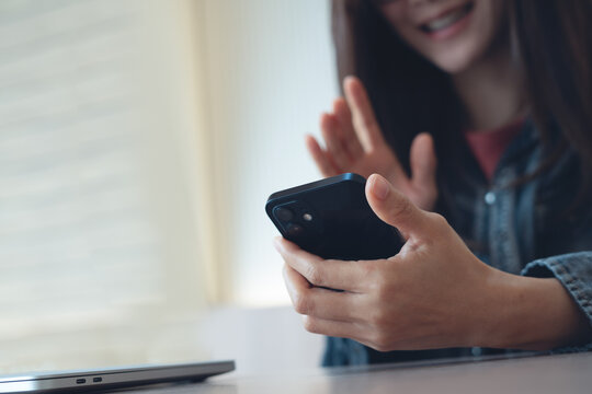 Smiling young asian woman using smartphone for video call at home, modern people lifestyle, close up