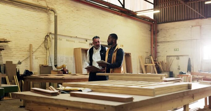 Carpentry, men and discussion with tablet in workshop for design review, invoice opinion or trade. Walking, carpenter team and tech in warehouse for stock checklist, production schedule and workflow
