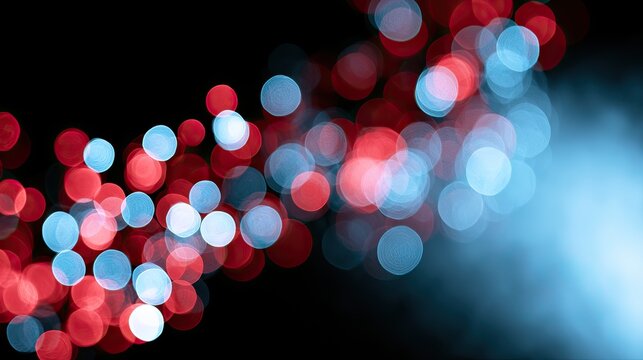 Glowing red and blue orbs softly illuminate a dark background with a hazy glow