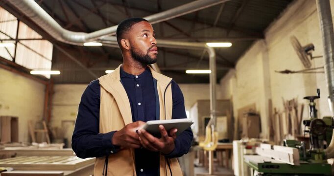 Thinking, black man and tablet at workshop for carpentry, research or inspection for wood production. Male person, carpenter and walk at factory with tech, quality control and manufacturing furniture