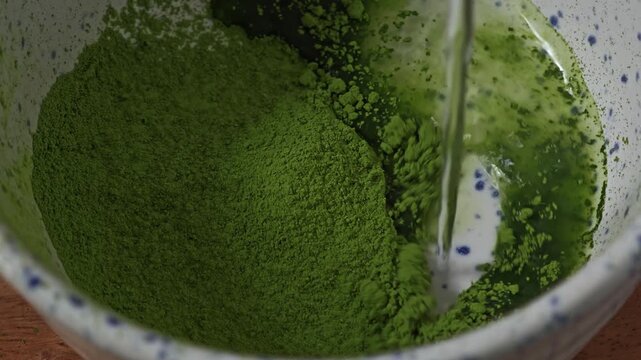 Matcha powder with warm water. Chashaku.