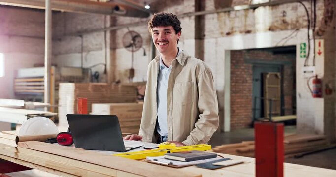 Face, carpenter and happy in workshop for manufacturing, trade and laptop for blueprint plans. Male person, smile and carpentry with tools for production, lumber factory and pride in profession