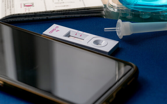 Covid 19 antigen self test for nasal swab with positive result. Antigen test kit for home use to detection coronavirus infection. Negative test result from rapid antigen test. Coronavirus diagnosis.