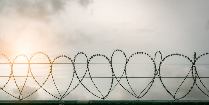 Prison security fence. Barbed wire security fence. Razor wire jail fence. Barrier border. Boundary security wall. Prison for arrest criminals or terrorists. Private area. Military zone concept.