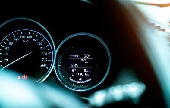 Closeup car fuel gauge dashboard panel. Gasoline indicator meter and speedometer. Fuel gauge show full gas tank. Data information dashboard show outside car temperature, trip range and fuel tank icon.