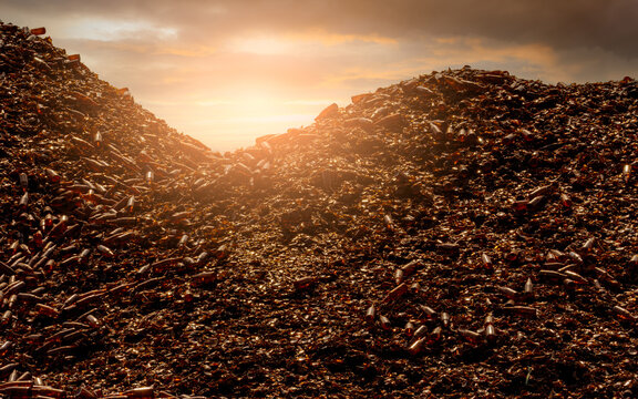 Pile of brown bottle for recycle in recycling factory. Glass waste for recycle. Dump of brown beer and wine glass bottle. Smashed glass bottle garbage. Recycling business. Sustainable glass packaging.