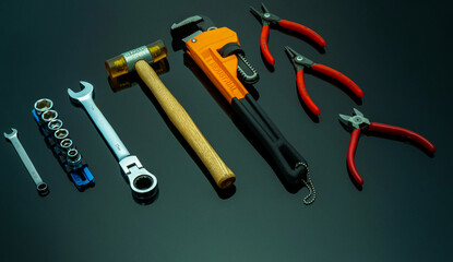 Set of mechanic tools on black background. Chrome wrenches or spanners, hexagon socket, end cutter pliers, locking pliers, pincers, plastic hammer, monkey pipe wrench. Chrome vanadium spanner wrench. © Fahroni