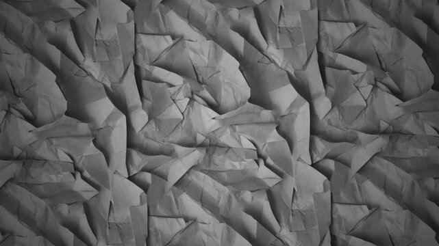 Crumpled and wrinkled white paper texture animation loop with dramatic, high-contrast organic shadows and deep artistic shades across the creased surface