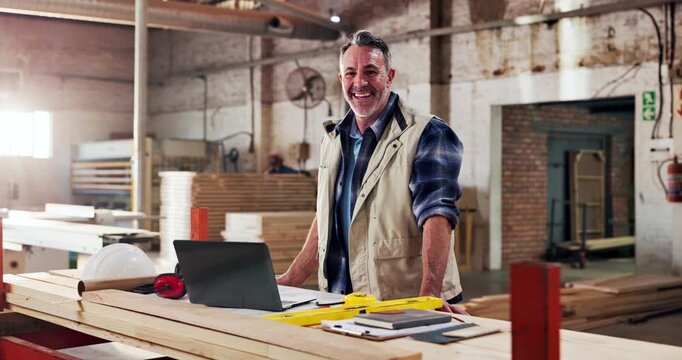 Face, carpenter and smile in workshop for manufacturing, trade and laptop for blueprint plans. Male person, mature and carpentry with tools for production, lumber factory or happy in profession
