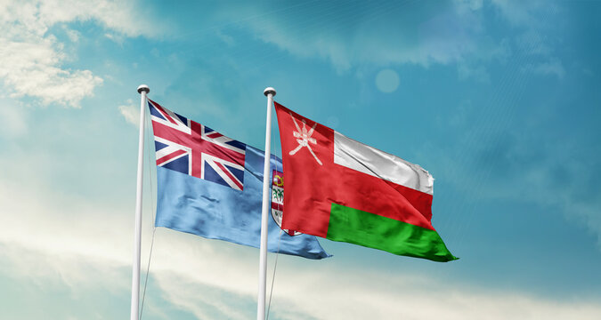 Fiji Oman friendship flags are waving in the sky. Two country flag for agreement or deal. Fiji Oman national flag for commitment.