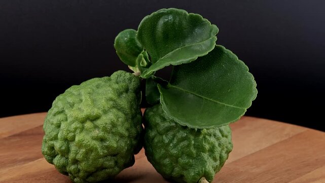 Sliced kaffir lime on wooden board. Zoom in.