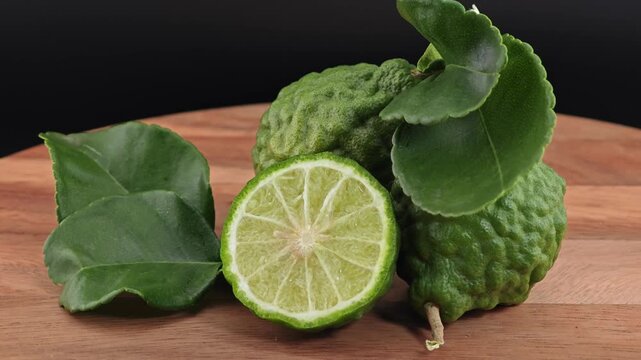 Sliced kaffir lime on wooden board.