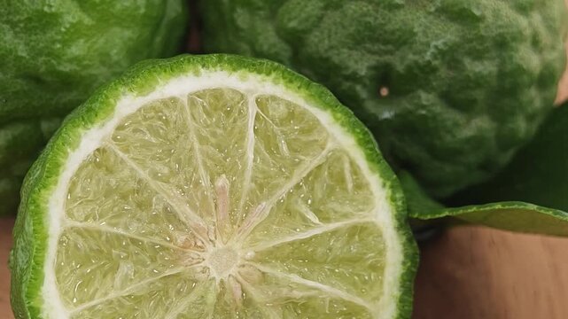 Sliced kaffir lime on wooden board.
