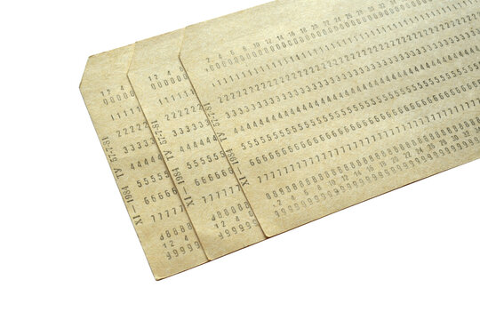 Three vintage punched cards isolated on white background, retro data storage concept