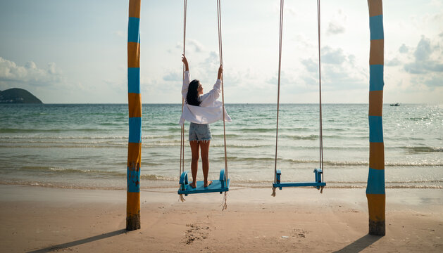 Carefree traveler feeling secure and protected while enjoying a dream vacation at a tropical beach