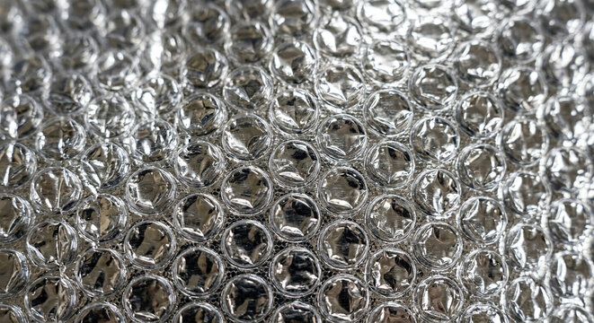 Close-up View of Transparent Bubble Wrap with Reflective Surface