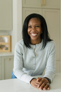 Happy Black woman smiling in a modern kitchen