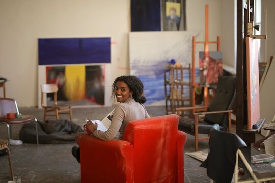 Happy young woman relaxing in a creative art studio