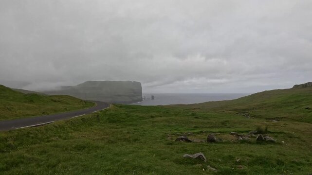 Fog over Eidiskollur cliff and Risin og Kellingin, Faroe Islands