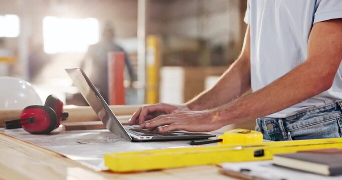 Hands, carpenter and typing in workshop with laptop, research and review design for production. Man, email and pc in factory for carpentry, online blueprint and compliance for manufacturing furniture