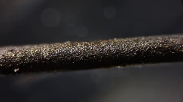 Macro video of pencil graphite lead under microscope, technology concept