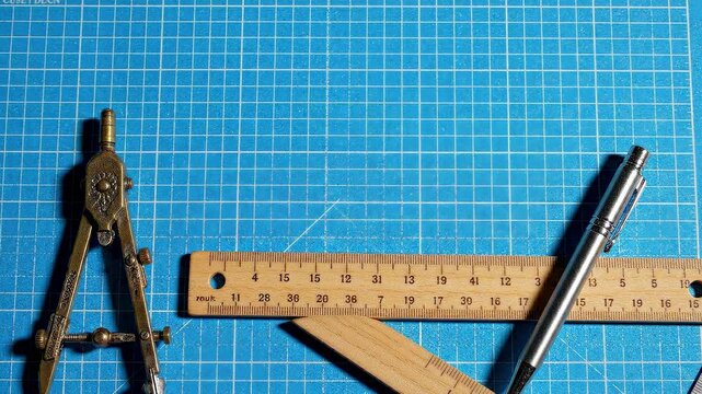Close-Up Precise Back to School Geometry and Drafting Tools on Grid Graph Paper