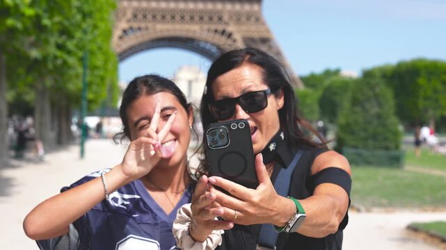 Family travel moment under Eiffel Tower Paris France.