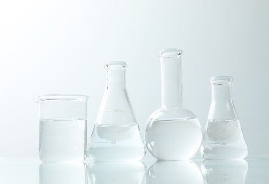 Set of different laboratory glassware on white background
