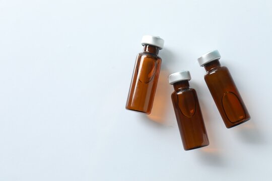 Small bottles with liquid. Examples of vaccines and other medical equipment. Top view