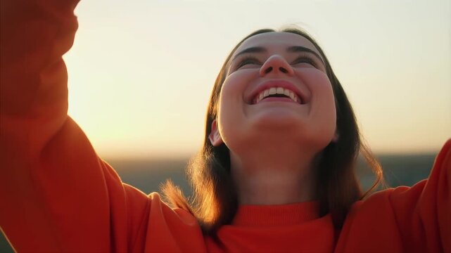 Close-up portrait of a person whose expression changes from neutral to a warm genuine smile, highlighting authentic emotion, optimism, confidence and natural human connection.