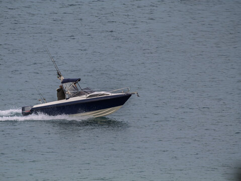 Blue And White Speeding Fishing Boat