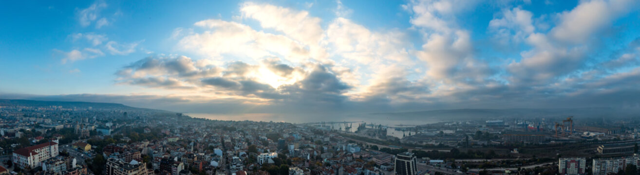 Beautiful high angle panoramic view of Varna city, port, and bay under a cloudy sky at sunrise