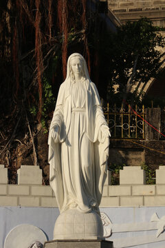 NHA TRANG, VIETNAM - JANUARY 26, 2026: A full-length, symmetrical front view close-up of the stone Virgin Mary Ave Maria statue.