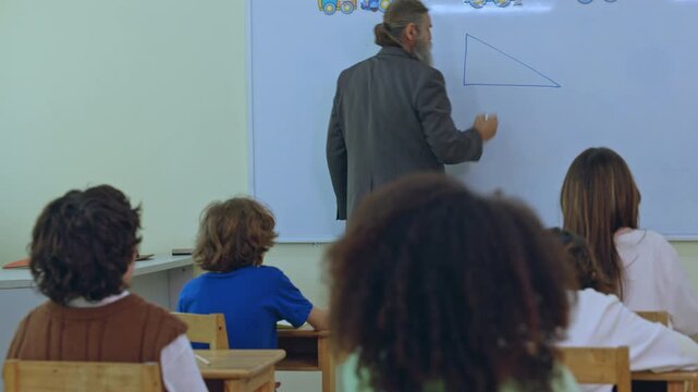 Teacher classroom student whiteboard lesson education drawing adult school learning geometry writing during school setting with seated group watching from desks