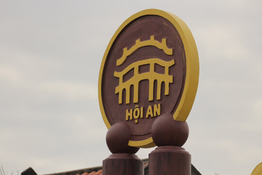 HOI AN, VIETNAM - JANUARY 25, 2026: A close-up view of a sculptural composition featuring the iconic symbol of Hoi An ancient town against a clear sky.