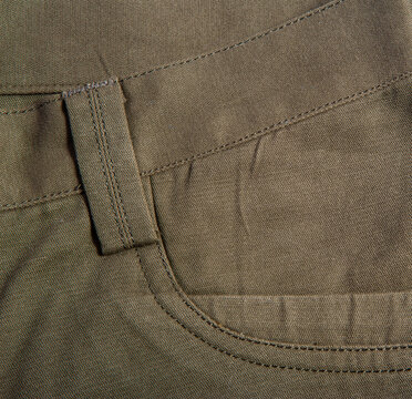 Detailed image of men's casual trousers on a white background