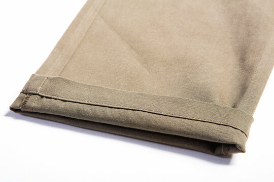 Detailed image of men's casual trousers on a white background