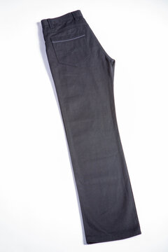 Detailed image of men's casual trousers on a white background