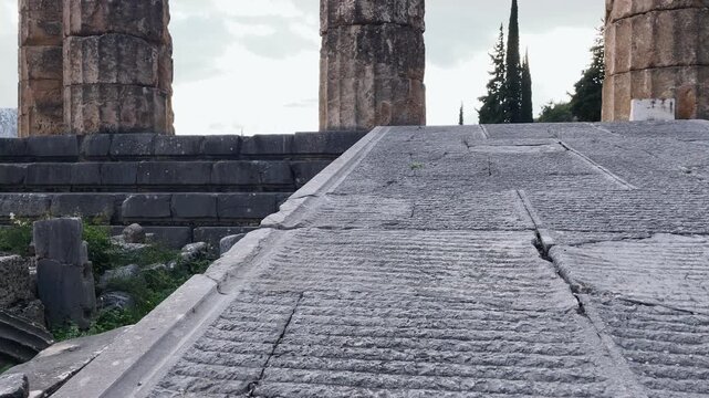 Pan up to the columns of the Temple of Apollo at the Sanctuary of Delphi, Greece
