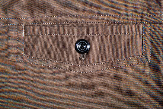 Detailed image of men's casual trousers on a white background