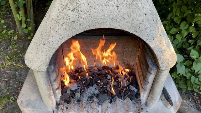 Flames Burning Over Charcoal in Outdoor Stone Grill