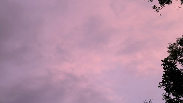 Pink and purple hues paint the cloudy sky at dusk
