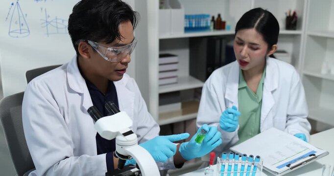 Scientists collaborate in a modern laboratory, analyzing samples with microscopes, pipettes, and test tubes while conducting biomedical research, scientific testing, and laboratory experiments.