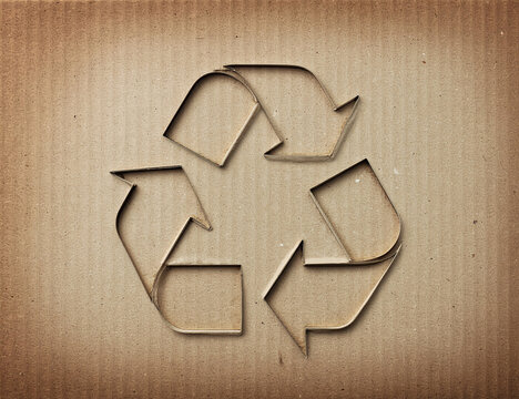 Sign of recycling on cardboard texture, sustainable packaging and circular economy concept. Generative AI