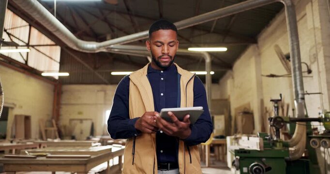 Black man, carpenter and walk in workshop with tablet, research and inspection for wood production. Thinking, person and supervision in factory with tech, quality control and manufacturing furniture