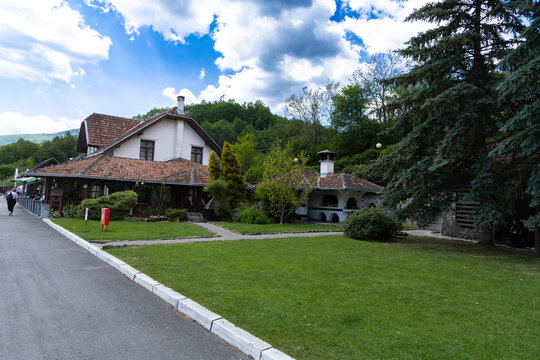 Serbia Mokra Gora 26.05.2026 Rustic Country House Garden Under Cloudy Sky