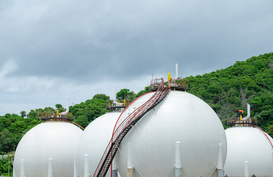 Industrial gas storage tank in factory, LNG or liquefied natural gas container in petroleum refinery. Energy industry infrastructure for natural gas storage. Global energy supply. Fuel reservoir.
